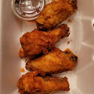 fried chicken wings in a styrofoam container