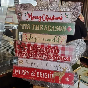 a stack of christmas signs