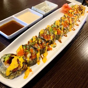 Godzilla roll: tempura roll with spicy tuna, avocado, eel top with spicy mayo, eel sauce, and hot sauce IG: @angelaisafoodie