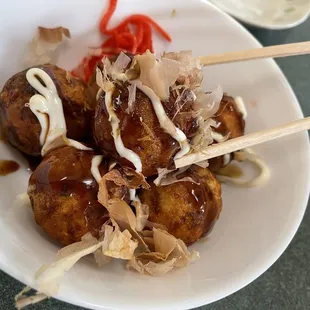 a bowl of food with chopsticks