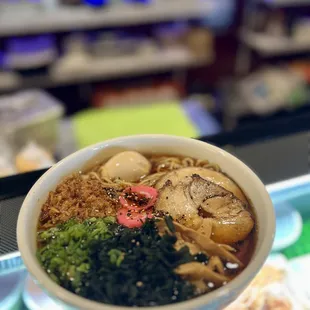 a bowl of ramen and broccoli