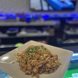 a plate of noodles and vegetables