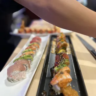 a person placing sushi on a plate