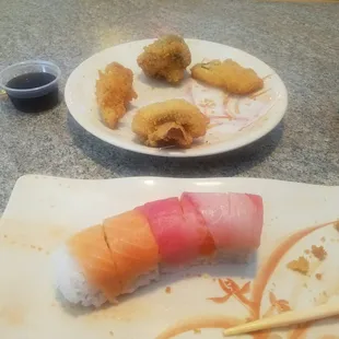 a plate of sushi and a plate of rolls