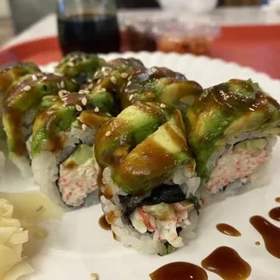 a plate of sushi with sauce