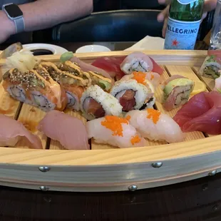 a wooden tray of sushi