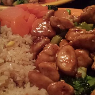 Chicken teriyaki with broccoli, sweet carrots, and fried rice.