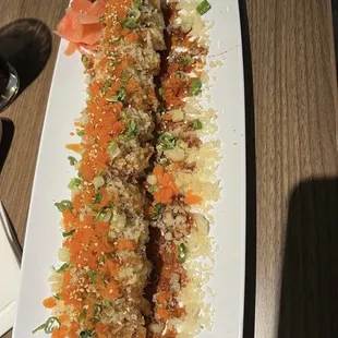 a plate of sushi with carrots and rice