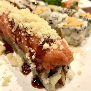 a plate of sushi and rolls