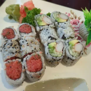 Two different sushi rolls. Spicy tuna on the left and a California roll on the right