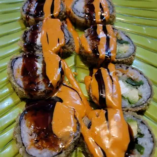 a plate of sushi with sauce