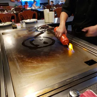 a person cooking on a grill