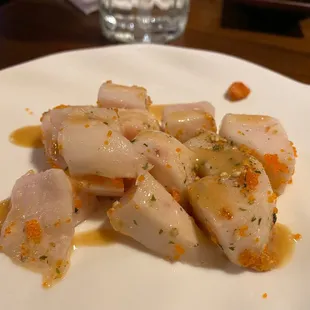 scallops with sauce on a white plate