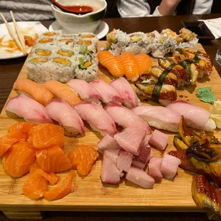 a variety of sushi on a cutting board