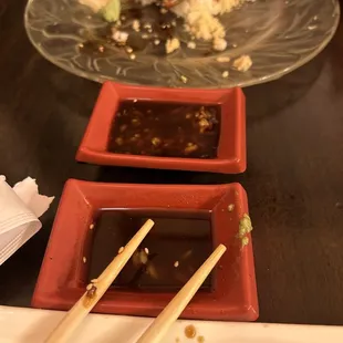 a plate of sushi and chopsticks