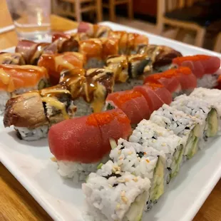 a plate of sushi and rolls