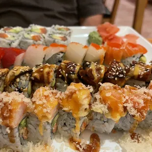 a plate of sushi and rolls