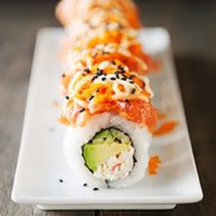 a sushi roll with salmon and avocado