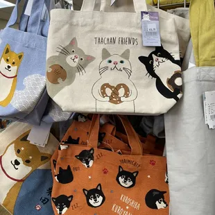 a variety of cat themed tote bags