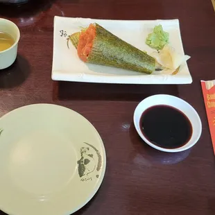 a plate of sushi and a cup of tea