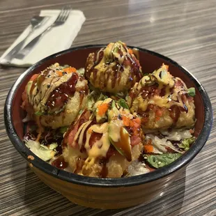 Spicy Tuna Cake - 
 Deep-fried sushi rice topped with avocado slices, spicy tuna, masago and sauce.