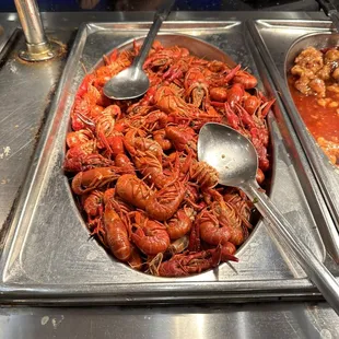 a little boy looking at a tray of craws
