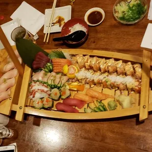 a wooden boat filled with sushi