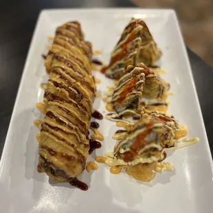 four pieces of food on a white plate