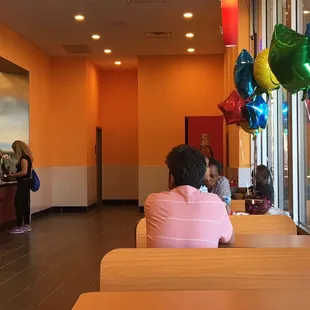 a woman sitting at a table in a restaurant