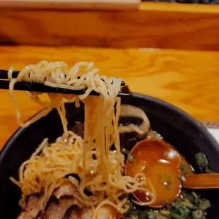 Tonkotsu Red ramen bowl with extra scallion while devouring