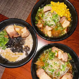 three bowls of food on a table