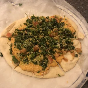 Flat bread with hummus and tabouli.