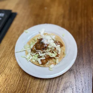 Complimentary &apos;salad&apos; before ordering - Fried corn tortilla, beans, cabbage, and salsa.