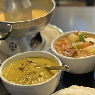 a bowl of soup and two bowls of rice