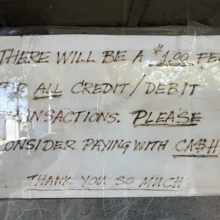 Sign from business asking for patrons to pay with cash.
