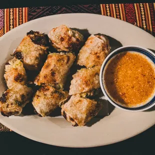 a plate of food with dipping sauce