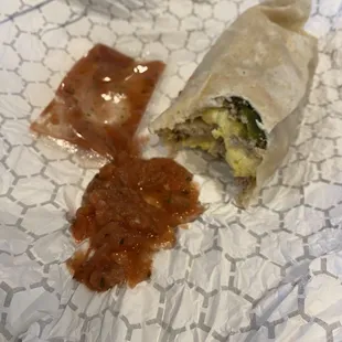 Breakfast burrito with salsa.