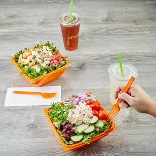 a person eating a salad and a drink