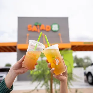 two people toasting with drinks