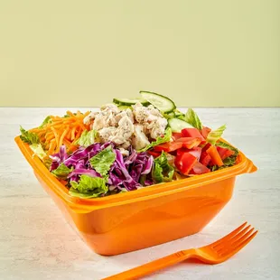 a salad in a bowl with a fork