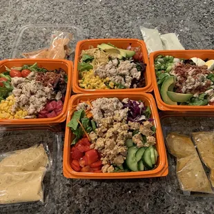 Clockwise from the top: Bbq chicken, Cobb w/ chicken, Thai w/ chicken &amp; tofu, jalapeño ranch w/ chicken. Extra dressing.