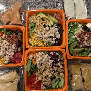 Clockwise from the top: Bbq chicken, Cobb w/ chicken, Thai w/ chicken &amp; tofu, jalapeño ranch w/ chicken. Extra dressing.