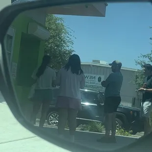 Long drive-thru line, people started parking and walking to window... only to find another long line.