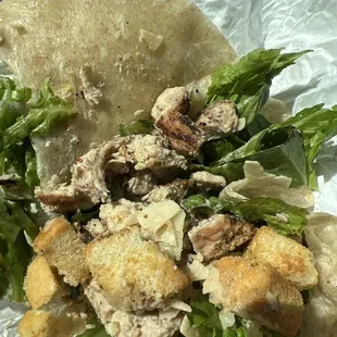 Inside of my burrito. Filled with perfectly grilled chicken, crunchy croutons, crispy lettuce, and tasty dried cheese/dressing.
