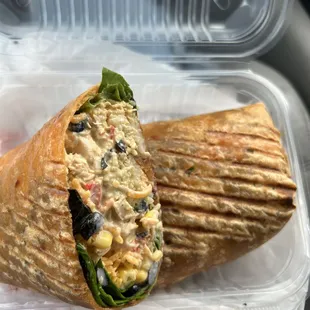 a chicken salad wrap in a styrofoam container