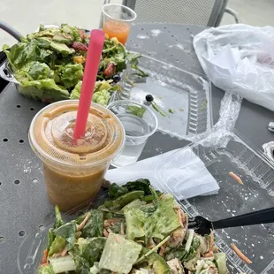 a salad and a drink on a table