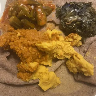 Vegan platter! Okra, collard greens, and I think two different lentil dishes. Plus injera, of course!