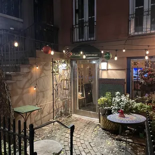 a courtyard with tables and chairs
