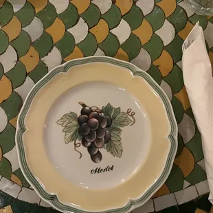 a plate with a bunch of grapes on it