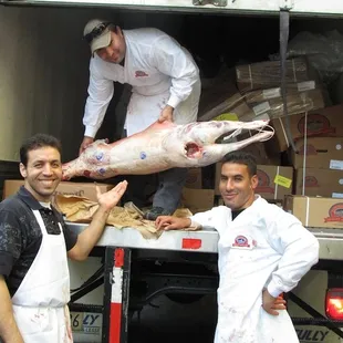 two men standing in front of a truck